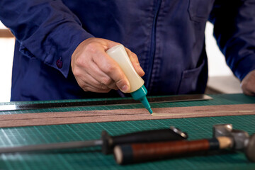application of glue to the leather, creation of a leather handicraft