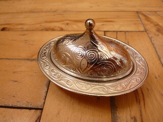 Elegance of Tradition: Ornate Silverware on a Wooden Floor, Symbolizing Timeless Heritage and the Craftsmanship of Generations