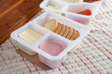 A view of a cracker sandwich building lunch kit.