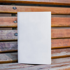 Blank book displayed on vintage wooden bench 