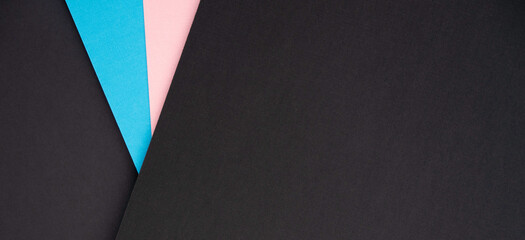 Abstract modern black and light blue and pink color background. Dark textured colored paper layout...