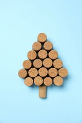 Christmas tree shaped wine corks on color background. Top view with copy space for text