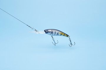 Fishing bait wobbler jig isolated on the bright blue fond background