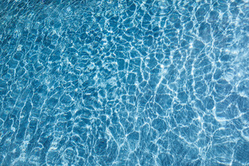 Blue water background. Swimming Pool. Pool edge.
