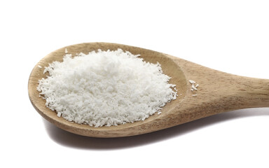 Pile grated coconut in wooden spoon isolated on white, side view	