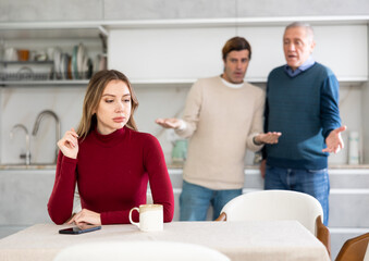 Fototapeta premium Men quarreling and arguing with girl, annoyed and emotional