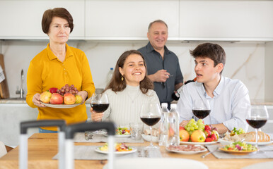 Happy family having dinner together at the festive table at home