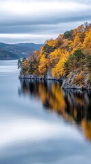 Fototapeta premium A breathtaking aerial perspective showcases a tranquil lake amidst vibrant autumn trees, highlighting the beauty of the Swedish wilderness