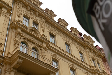 The facade of a beautifully historic building features intricate decorations and stunning balconies