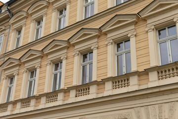 The buildings ornate facade features various windows, enriched by a rich historical context