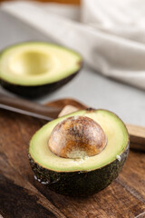 Fresh avocado on a wooden cutting board