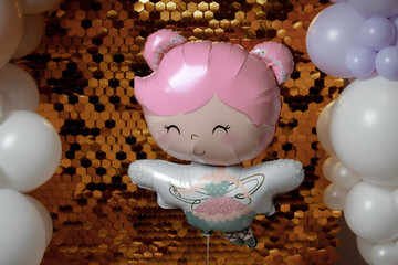 Shiny photo zone with golden mosaic and colored balloons. Aerodesign of children's parties. Theme - first year of the child. Helium balloon in the form of a hat with the inscription 1st birthday