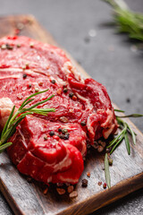 Raw beef meat on a wooden cutting board