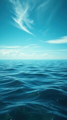 Fototapeta premium Ocean blue-green waters with a few wispy clouds in the distance reflecting on the surface , nature, outdoor