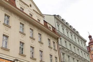 Fototapeta premium Historic facades of beautifully designed buildings in a picturesque European city are majestic under clouds