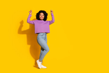 Full length photo of pretty young woman hold empty space placard isolated on yellow color background