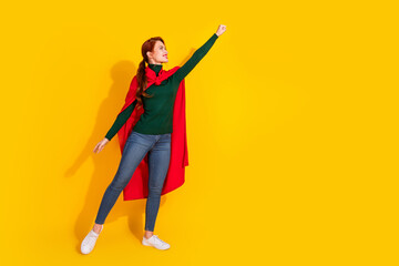 Full length photo of charming positive woman wear green turtleneck red cape hurrying empty space isolated yellow color background