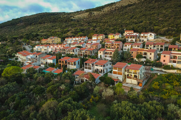 Obraz premium View of village of Ravni, Eastern istria, Croatia. A collection of houses for weekends on the sloping hill in morning sun