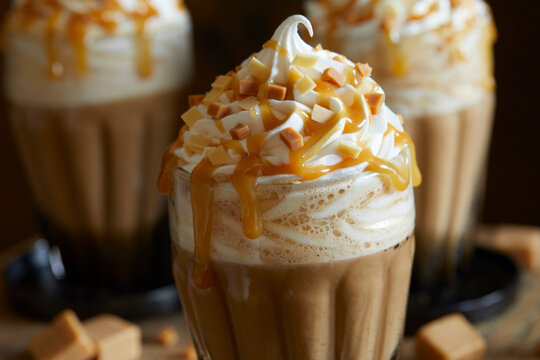 Three fresh caramel lattes, with cream topping, salted caramel sauce and toffee pieces
