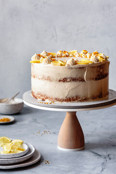 A beautifully decorated lemon layer cake on a marble background