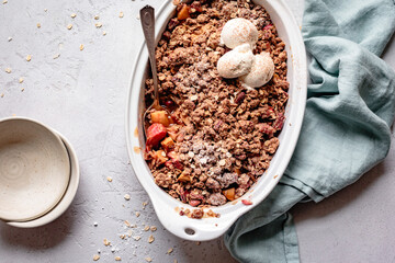 Apple rhubarb crisp in an oval baking dish