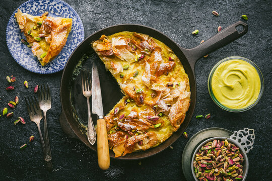 Ruffled Phyllo Pistachio Pie, icing sugar and crushed pistachios, Sliced