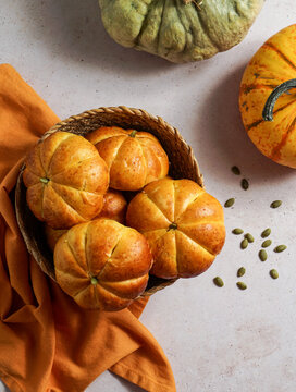 Pumpkin buns yeast bread with spices on linen background. Thanksgiving Food Concept. Autumn concept, top view, halloween