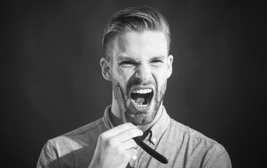 Screaming bearded man with straight razor. Barber shop, hairdresser, shaving beard. Angry young man with straight razor. Barbershop. Beard man, bearded male. Barber tools for shaving. Black and white.