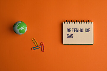 There is notebook with the word Greenhouse Gas. It is as an eye-catching image.