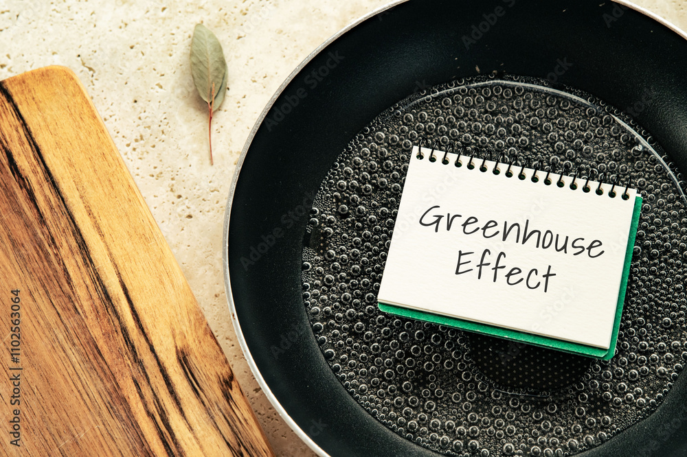 Poster there is notebook with the word greenhouse effect. it is as an eye-catching image.