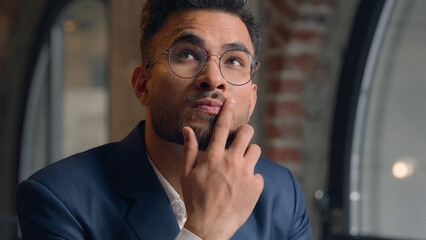Thoughtful puzzled businessman Arabian Indian man thinking male guy employer worker think idea...