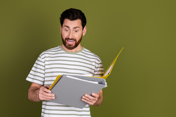 Photo of handsome successful man wear stylish clothes read folders isolated on khaki color background