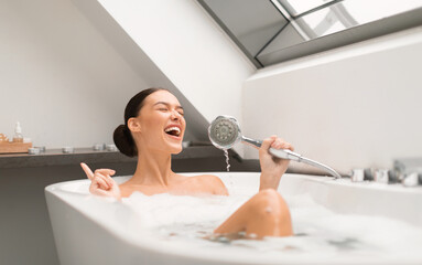 Woman Singing Taking Bath With Foam, Having Fun Holding Shower Head Like Microphone Relaxing In...