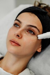 Woman receiving skincare treatment in a modern beauty clinic