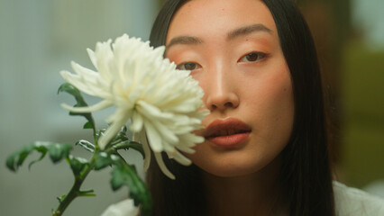 Asian woman girl Chinese Korean Japanese lady female beautiful face smell flower blossom fresh...