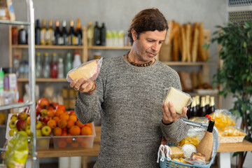 In cozy rustic market filled with freshly baked bread and vibrant produce, middle-aged man with...