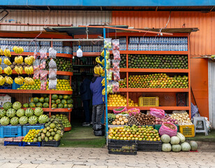 People shop at an outdoor fruit market in Addis Ababa