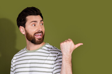 Photo of handsome nice man wear trendy clothes recommend empty space isolated on khaki color background