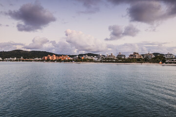 Beautiful coastal view showing buildings along the shoreline during twilight