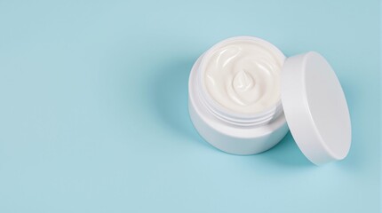 A simple white jar of face cream with the lid slightly open on a solid light blue background