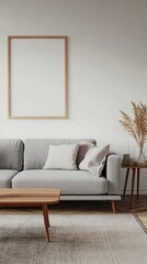 Minimalist living room with gray sofa, wooden coffee table, and empty frame on white wall. Pampas grass adds natural touch to serene space.
