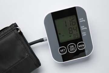 Blood pressure measuring device on white background, top view