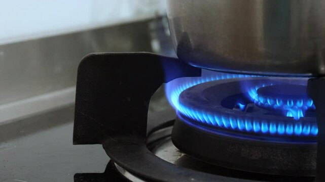The footage of the fire from the gas stove beneath the cooking pot, boiling the soup.