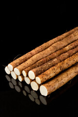 Fresh chinese yam ingredients on black background.