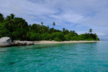 Indonesia Anambas Islands - Idyllic coast with stones, beach and palm trees