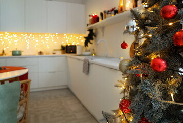 Christmas tree with balls in kitchen, closeup