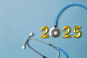 2025 New year for healthcare concept.Stethoscope with 2025 gold number on blue background.health...