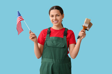 Female painter with USA flag and paint brushes on blue background