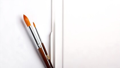 Fototapeta premium Artistic display of fine brushes on pure white canvas.