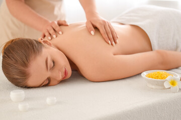 Obraz premium Relaxing back massage for young woman in spa salon, wellness and self care treatment, beauty and body care